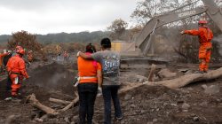 Eva Ascon, is embraced by a family member as rescue workers search for her rest of her family at the affected by the Fuego volcano at San Miguel Los Lotes in Escuintla, Guatemala June 15, 2018. REUTERS/Carlos Jasso