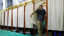 A man leaves a booth during Hungarian parliamentary election at a polling station in Budapest, Hungary, April 8, 2018. REUTERS/Leonhard Foeger