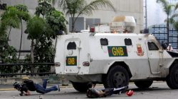 Demonstrators fall on the ground after being hit by a riot police armoured vehicle while clashing with the riot police during a rally against Venezuelan President Nicolas Maduro in Caracas, Venezuela, May 3, 2017. REUTERS/Marco Bello/File Photo
