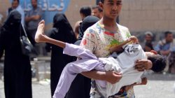 A displaced boy from Hodeidah city carries his brother who is affected by monoplegia, at a school where displaced people live, in Sanaa, Yemen June 22, 2018. REUTERS/Mohamed al-Sayaghi