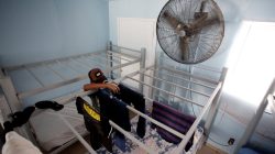A Mexican migrant child arranges freshly-washed clothing at the Senda de Vida migrant shelter in Reynosa, in Tamaulipas state, Mexico June 22, 2018. Picture taken June 22, 2018. REUTERS/Daniel Becerril