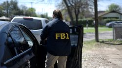 An FBI agent exits her car in Austin, Texas, U.S., March 12, 2018. REUTERS/Sergio Flores
