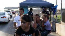 A Honduran family seeking asylum waits on the Mexican side of the Brownsville & Matamoros International Bridge after being denied entry by U.S. Customs and Border Protection officers near Brownsville, Texas, U.S., June 26, 2018. Picture taken June 26, 2018. REUTERS/Loren Elliott