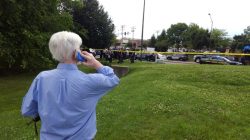 E.B Furgurson talk on the phone as police officers respond to an active shooter inside a city building in Annapolis, Maryland, U.S., June 28, 2018. REUTERS/Greg Savoy