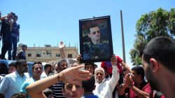 Residents celebrate the army's arrival in the formerly rebel-held town of Ibta, northeast of Deraa city, Syria in this handout released on June 29, 2018. SANA/Handout via REUTERS