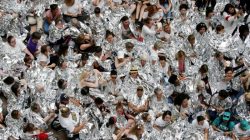 Immigration activists wrapped in silver blankets, symbolising immigrant children that were seen in similar blankets at a U.S.-Mexico border detention facility in Texas, protest inside the Hart Senate Office Building after marching to Capitol Hill in Washington, U.S., June 28, 2018. REUTERS/Jonathan Ernst