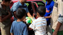 A child receives packages of corn flour in exchange for fish in Rio Chico, Venezuela June 14, 2018. REUTERS/Marco Bello