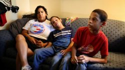 Jaykarey Skerett, a Puerto Rican mother whose home was destroyed by Hurricane Maria, sits with her two sons for an interview in her hotel room in Kissimmee, Florida, U.S. July 2 2018. Picture taken July 2, 2018. REUTERS/Joey Roule