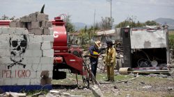 A firefighter talks to a resident at a site damaged due to fireworks explosions in the municipality of Tultepec, on the outskirts of Mexico City, Mexico July 5, 2018. REUTERS/Daniel Becerril