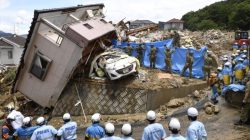 Rescue workers look for missing people in a house damaged by heavy rain in Kumano town, Hiroshima Prefecture, Japan, in this photo taken by Kyodo July 9, 2018. Mandatory credit Kyodo/via REUTERS