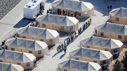 FILE PHOTO: Immigrant children now housed in a tent encampment under the new "zero tolerance" policy by the Trump administration are shown walking in single file at the facility near the Mexican border in Tornillo, Texas, U.S. June 19, 2018. REUTERS/Mike Blake/File Photo