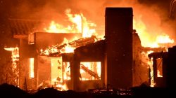 A house burns as firefighters battle a fast-moving wildfire that destroyed homes driven by strong wind and high temperatures forcing thousands of residents to evacuate in Goleta, California, U.S., early July 7, 2018. REUTERS/Gene Blevin