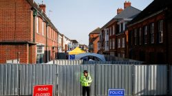 FILE PHOTO: A police officer stands in front of screening erected behind John Baker House, after it was confirmed that two people had been poisoned with the nerve-agent Novichok, in Amesbury, Britain, July 5, 2018. REUTERS/Henry Nicholls/File Photo