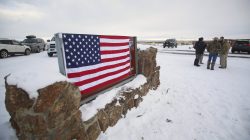 FILE PHOTO: A U.S. flag covers a sign at the entrance of the Malheur National Wildlife Refuge near Burns, Oregon, U.S. January 3, 2016. REUTERS/Jim Urquhart/File Photo