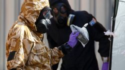 FILE PHOTO: Forensic investigators, wearing protective suits, emerge from the rear of John Baker House, after it was confirmed that two people had been poisoned with the nerve-agent Novichok, in Amesbury, Britain, July 6, 2018. REUTERS/Henry Nicholls/File Photo