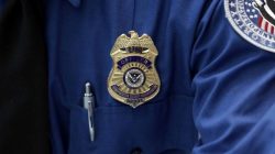 FILE PHOTO: A Transportation Security Administration (TSA) official's wears a TSA badge at Terminal 4 of JFK airport in New York City, U.S., May 17, 2017. REUTERS/Joe Penney/File Photo