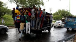 Commuters ride on a cargo truck used as public transportation in Valencia, Venezuela July 11, 2018. Picture taken July 11, 2018. REUTERS/Marco Bello