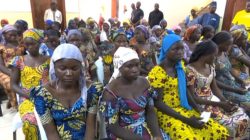 FILE PHOTO: A still image taken from video shows a group of girls, released by Boko Haram jihadists after kidnapping them in 2014 in the north Nigerian town of Chibok, sitting in a hall as they are welcomed by officials in Abuja, Nigeria, May 7, 2017. REUTERS/via Reuters TVREUTERS/ /File Photo