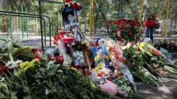 A woman places flowers at the site of the assassination of Kazakhstan's Olympic figure skater Denis Ten in Almaty, Kazakhstan July 20, 2018. REUTERS/Shamil Zhumatov - RC1B8C889C90