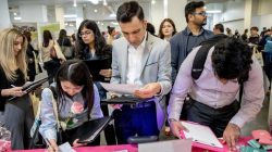 FILE PHOTO: Job seekers and recruiters gather at TechFair in Los Angeles, California, U.S. March 8, 2018. REUTERS/Monica Almeida