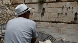 A man looks at a stone that fell off the Western Wall in Jerusalem's Old City, July 23, 2018. REUTERS/ Nir Elias