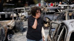 A woman reacts as she tries to find her dog, following a wildfire at the village of Mati, near Athens, Greece July 24, 2018. REUTERS/Costas Baltas