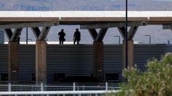 Security officers keep watch over a tent encampment housing immigrant children just north of the Mexican border in Tornillo, Texas, June 20, 2018. REUTERS/Mike