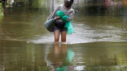 A woman wades through a flooded village after heavy rainfall caused by tropical storm Son Tinh in Ninh Binh province, Vietnam, July 22, 2018. REUTERS/Kham