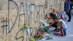 People write messages on construction boarding after a mass shooting on Danforth Avenue in Toronto, Canada, July 24, 2018. REUTERS/Chris Helgren