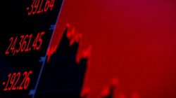 FILE PHOTO: The Dow Jones Industrial average is displayed on a screen after the closing bell at the New York Stock Exchange (NYSE) in New York, U.S., May 29, 2018. REUTERS/Brendan McDermid/File Photo