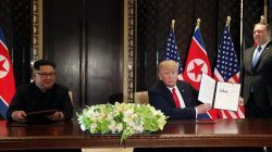 FILE PHOTO: U.S. President Donald Trump shows the document, that he and North Korea's leader Kim Jong Un signed acknowledging the progress of the talks and pledge to keep momentum going, after their summit at the Capella Hotel on Sentosa island in Singapore June 12, 2018. At right is U.S. Secretary of State Mike Pompeo. REUTERS/Jonathan Ernst/File Photo