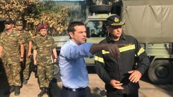 Greek Prime Minister Alexis Tsipras speaks with a firefighter officer as he visits the village of Mati, following a wildfire near Athens, Greece, July 30, 2018. Greek Prime Minister's Press Office/Handout via REUTERS