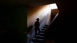 Elizabeth Altuve climbs the stairs at the occupied building where she lives in Maracaibo, Venezuela July 26, 2018. Picture taken July 26, 2018. REUTERS/Marco Bell
