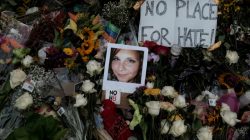 FILE PHOTO: A photograph of Charlottesville victim Heather Heyer is seen amongst flowers left at the scene of the car attack on a group of counter-protesters that took her life during the "Unite the Right" rally as people continue to react to the weekend violence in Charlottesville, Virginia, U.S. on August 14, 2017. REUTERS/Justin Ide/File Photo