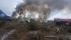 Firefighters douse a fire as smoke billows above the site where an Aeromexico-operated Embraer passenger jet crashed in Mexico's northern state of Durango, July 31, 2018, in this picture obtained from social media. Proteccion Civil Durango/via REUTERS