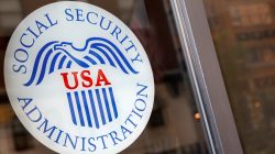 A sign is seen on the entrance to a Social Security office in New York City, U.S., July 16, 2018. REUTERS/Brendan McDermid