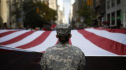 U.S. Army soldiers carry a large U.S. flag as they march in the Veterans Day parade on 5th Avenue in New York November 11, 2014. REUTERS/Mike Segar
