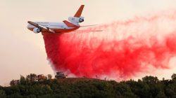 A DC-10 air tanker drops fire retardant along the crest of a hill to protect the two bulldozers below that were cutting fire lines at the River Fire (Mendocino Complex) near Lakeport, California, U.S. August 2, 2018. REUTERS/Fred Greaves