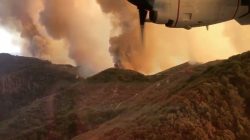 Aerial view of Trabuco Canyon as a tanker aircraft dumps load onto Holy Fire, Near Santiago Peak, California, U.S., August 6, 2018 in this still image taken from a video obtained from social media. TWITTER / @ZULUJUMPER/via REUTERS