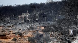 FILE PHOTO: A local walks on a burnt slope following a wildfire at the village of Mati, near Athens, Greece, July 24, 2018. REUTERS/Alkis Konstantinidis/File Photo