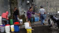 A woman carries a container filled with water coming from a mountain, in a road at Plan de Manzano slum in Caracas, Venezuela July 20, 2018. REUTERS/Marco Bello
