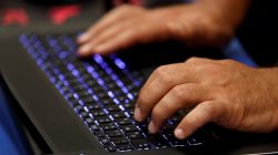 FILE PHOTO: A man types into a keyboard during the Def Con hacker convention in Las Vegas, Nevada, U.S. on July 29, 2017. REUTERS/Steve Marcus/File Photo