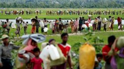 Rohingya refugees, who crossed the border from Myanmar two days before, walk after they received permission from the Bangladeshi army to continue on to the refugee camps, in Palang Khali, near Cox's Bazar, Bangladesh October 19, 2017. Reuters photographer Jorge Silva: "This picture was taken after a huge group of people crossed into Bangladesh and then had to wait three days and nights for the Bangladeshi Army's permission to continue walking into the makeshift camps. The line of people seemed endless. Long hours moving slowly across the embankments of the rice field. Mothers with babies and pregnant women, elderly people with illnesses, men carrying their entire life on their shoulders. They were safe from violence, but the challenge of surviving was still waiting for them on this side of the river." REUTERS/Jorge Silva/File Photo