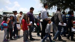 FILE PHOTO - Undocumented immigrant families walk from a bus depot to a respite center after being released from detention in McAllen, Texas, U.S., July 26, 2018. REUTERS/Loren Elliott