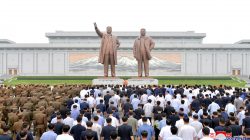 People and soldiers gather to offer flowers to the statues of state founder Kim Il Sung and former leader Kim Jong Il on the Day of Songun at Mansu hill, Pyongyang, North Korea, in this undated photo released by North Korea's Korean Central News Agency (KCNA) on August 26, 2018. KCNA via REUTERS