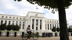 A cyclist passes the Federal Reserve building in Washington, DC, U.S., August 22, 2018. REUTERS/Chris Watti