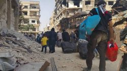 People carry their belongings before being evacuated from the besieged Damascus suburb of Daraya, after an agreement reached on Thursday between rebels and Syria's army, in this handout picture provided by SANA on August 26, 2016. SANA/Handout via REUTERS