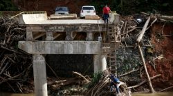 FILE PHOTO: A woman looks as her husband climbs down a ladder at a partially destroyed bridge, after Hurricane Maria hit the area in September, in Utuado, Puerto Rico, November 9, 2017. REUTERS/Alvin Baez/File Photo