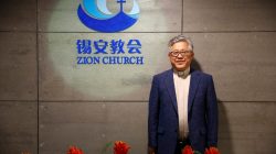 FILE PHOTO: The head pastor of the Zion church in Beijing Jin Mingri poses for picures in the lobby of the unofficial Protestant "house" church in Beijing, China, August 28, 2018. Picture taken August 28, 2018. REUTERS/Thomas Peter
