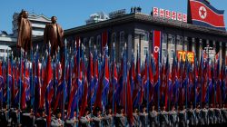 People carry flags in front of statues of North Korea founder Kim Il Sung (L) and late leader Kim Jong Il during a military parade marking the 70th anniversary of North Korea's foundation in Pyongyang, North Korea, September 9, 2018. REUTERS/Danish Siddiqui